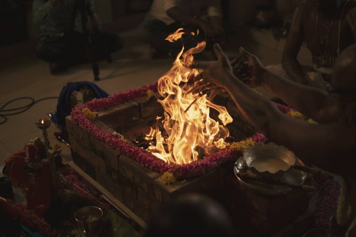 A sacred fire burning in a havan kund during a puja