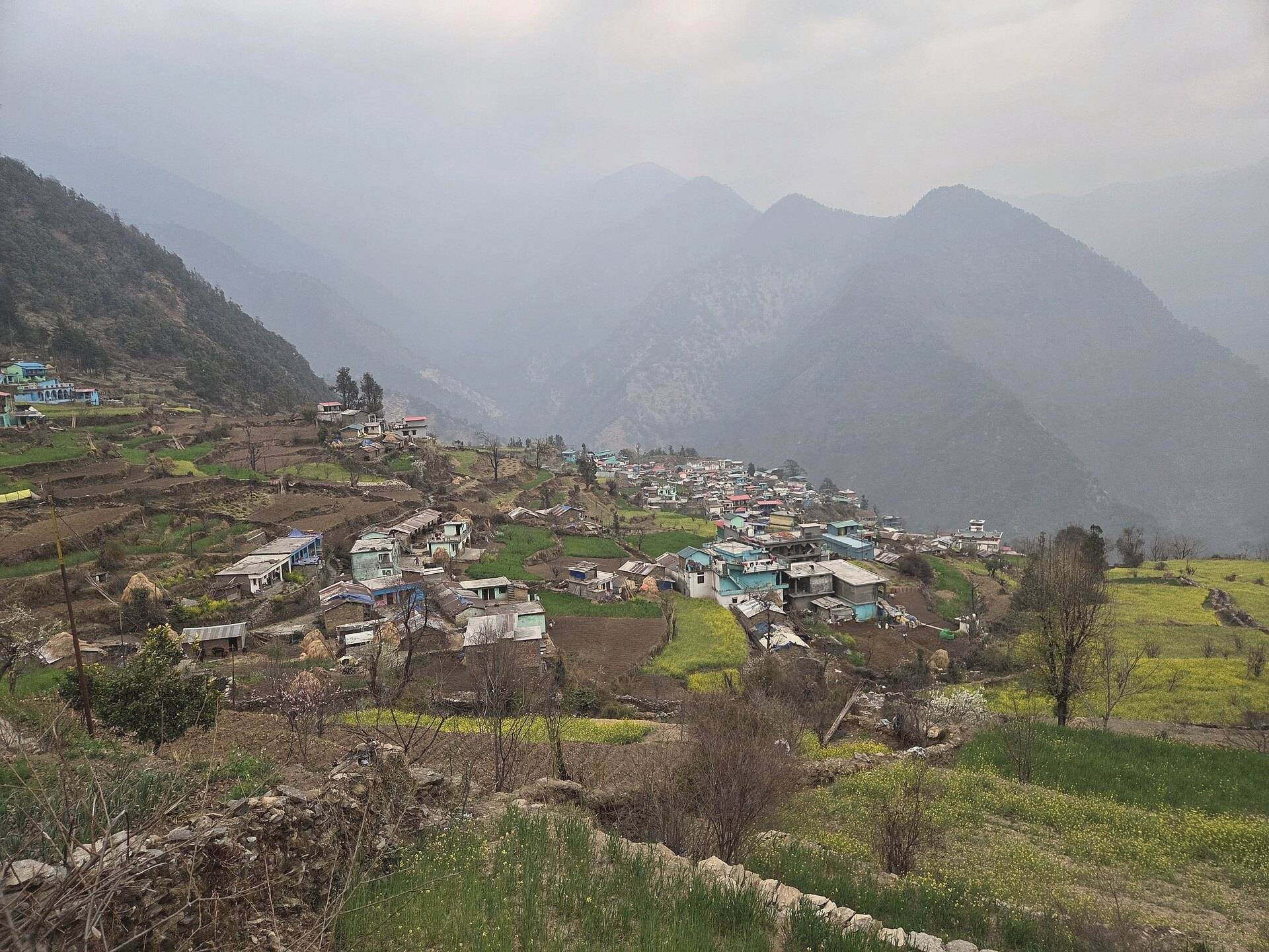 Triyuginarayan village on terraced hillsides with mountains beyond