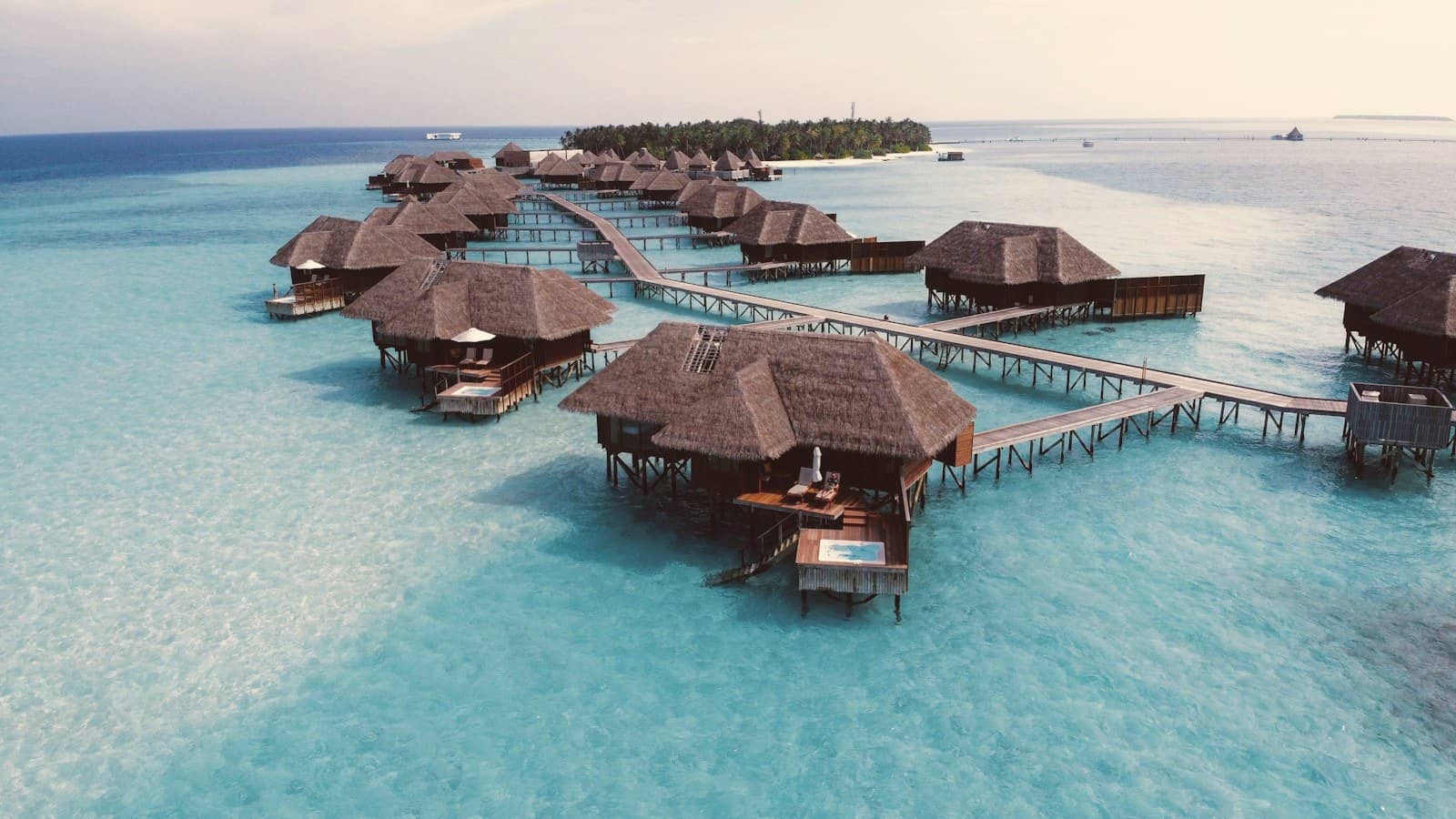 Overwater villas on stilts above a turquoise lagoon in the Maldives