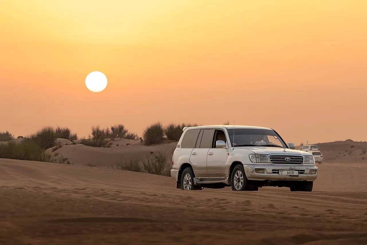 A 4x4 driving over the dunes outside Dubai
